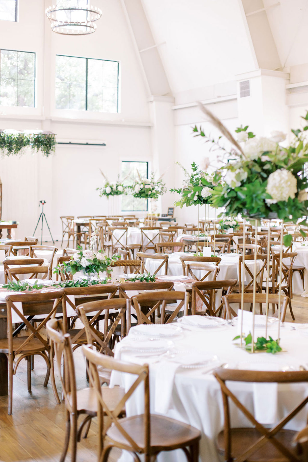 Beautiful indoor reception space for a wedding with plenty of seating and natural light.